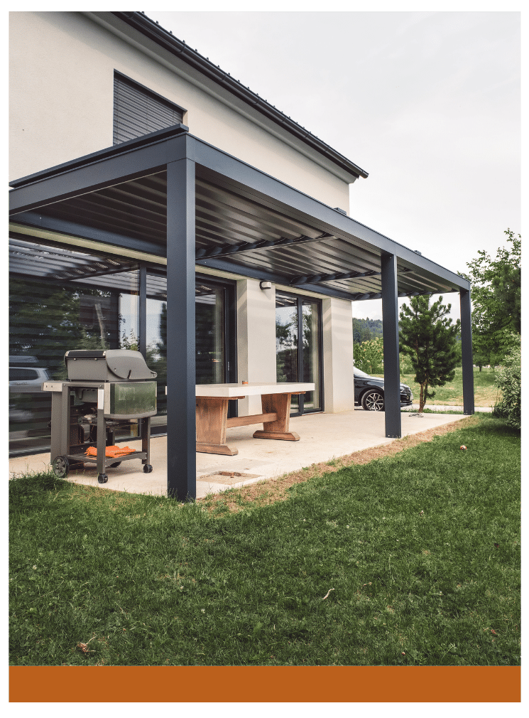 Contemporary patio with a sleek pergola, barbecue setup, and outdoor dining table on a landscaped lawn.