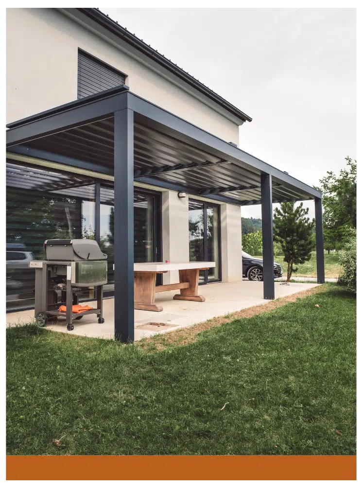 Contemporary patio with a sleek pergola, barbecue setup, and outdoor dining table on a landscaped lawn.