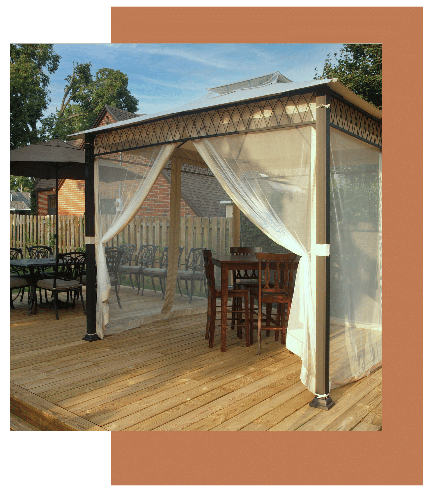 Outdoor screened canopy on a wooden deck with dining tables and chairs
