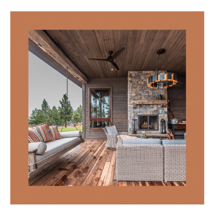Rustic covered porch with fireplace and TREX composite decking for low-maintenance outdoor comfort