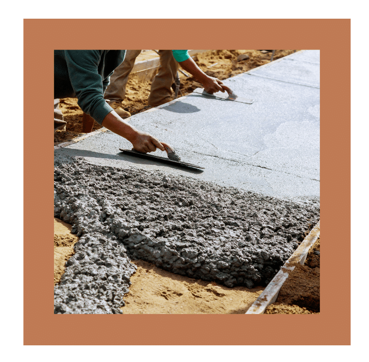 Workers leveling freshly poured concrete as a foundation for TREX composite decking installation